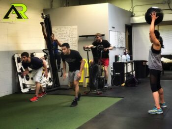 Several athletes working on their sport specific skills and doing various activities.