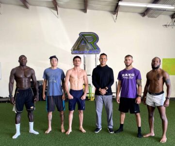 PRO MMA FIGHTERS A group of professional MMA fighters with their coach.