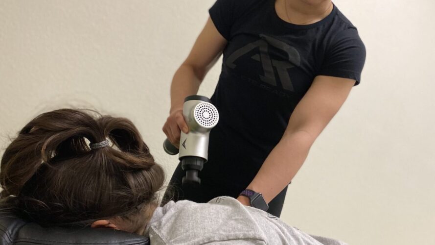 rest-and-recovery Athlete getting a massage with a massage gun.