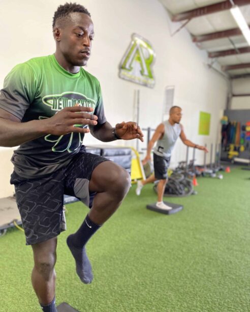 speed-agility Athletes working on their speed and agility doing one-legged drills.