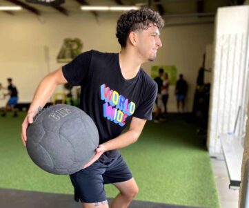strength-conditioning An athlete throwing a medicine ball against the wall.
